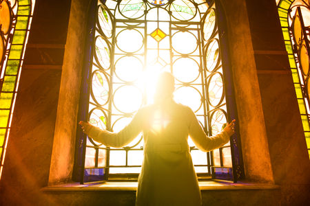 52647725 - religious christian woman looking trough the stained glass church window light.woman praying to god at st. alexander nevsky cathedral.finding serenity in religion,faith and hope concept.enlightenment